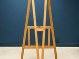 an image of a wooden ladder stands against a blue wall