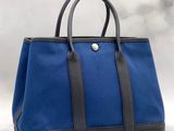 a blue and black tote bag on a white background