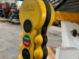 a close up of a yellow stop light in a warehouse