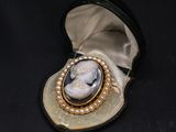 an image of a broochle of a woman with pearls in it