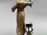 an image of a statue of a woman drinking from a water fountain