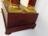 three vases that are sitting on a wooden stand