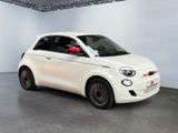 a small white car parked in a large room