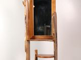 a wooden chair that is next to a wooden cabinet