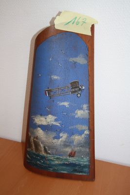 a picture of an airplane painted on a piece of wood