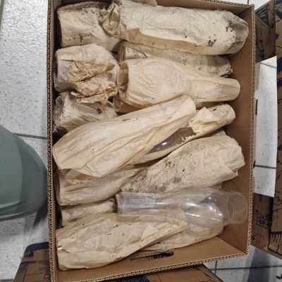 a cardboard box with a bunch of bags in it