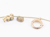 two pieces of jewelry that are on a chain