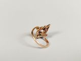 a close up of a gold ring on a white surface