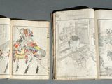 trois livres ouverts, sur lesquels figurent des dessins représentant des personnes, posés sur une surface bleue