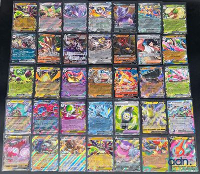a close up of a pile of pokemon cards sitting on top of a table