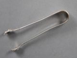 a silver spoon with a long handle on a table