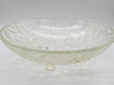 clear glass bowl sitting on a white surface with a white background