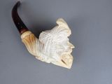 a carved pipe with a man ' s face on it
