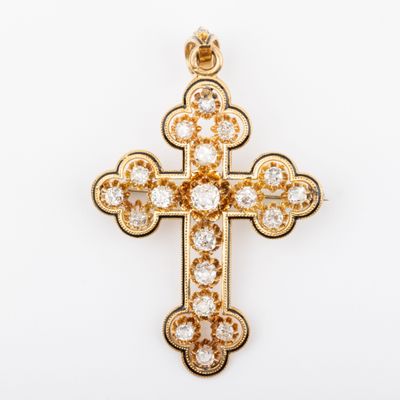 a gold and diamond cross pendant on a white background