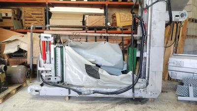 a machine that is sitting in a garage with a sheet covering it