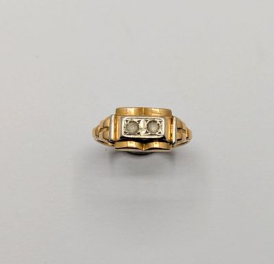 a gold ring with a diamond and two diamonds in the center