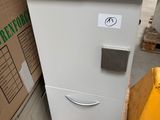 a refrigerator that is sitting on a pallet in a warehouse