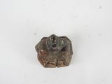 a small metal object that is on a white surface