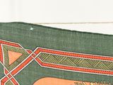 a close up of a green cloth with a design on it