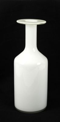 a white vase that is sitting on a table