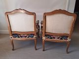 pair of antique chairs with upholstered back cushions in a living room