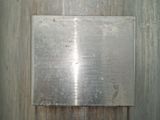 une plaque métallique fixée au mur d'un immeuble