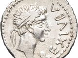a close up of a silver coin with a woman ' s head on it