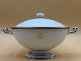 a close up of a bowl with a lid on a table