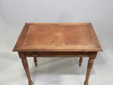 an old wooden table with a drawer on top of it