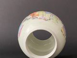 a white vase with a map on it on a table
