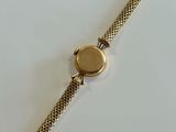 an image of a close up of a wrist watch on a white surface