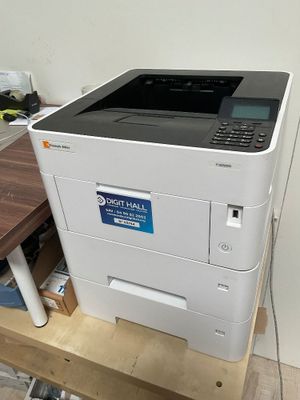 a printer that is sitting on top of a wooden table