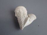 a white figurine of a man with a beard and a pipe