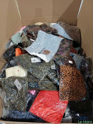 a cardboard box full of clothes and other items