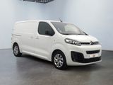 the white van is parked in a large white room