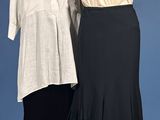 two women ' s dresses on a mannequin stand against a blue background