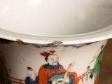 a white vase with a picture of a man and a woman on it