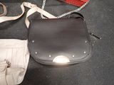a purse that is sitting on the floor next to a pair of scissors