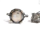 two silver objects sitting next to each other on a white surface