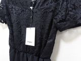 a close up of a dress hanging on a hanger on a wall