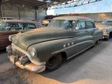 many old cars parked in a parking lot next to each other