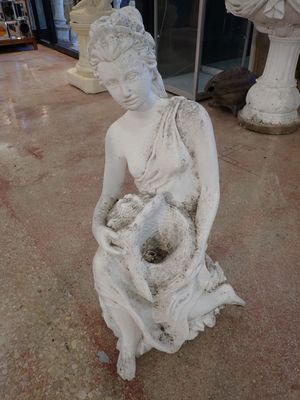 a statue of a woman holding a flower in her hands