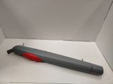 a gray and red pen sitting on top of a white box