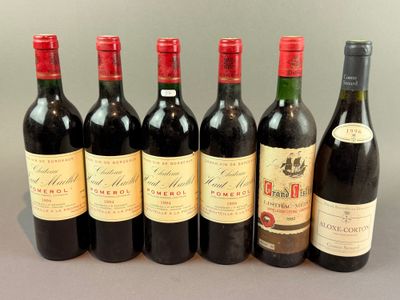 several bottles of wine are lined up on a table