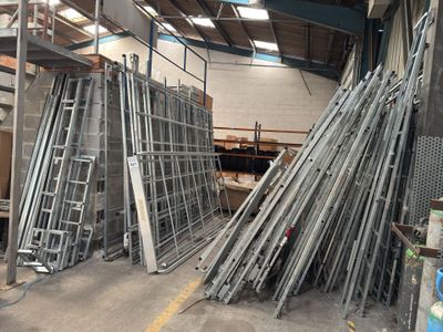 many pieces of metal that are stacked up in a warehouse