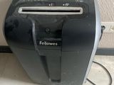 a black and silver paper shredder sitting on the floor