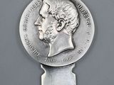 a close up of a spoon with a coin on top of it