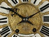 a gold clock with black and white numbers on it