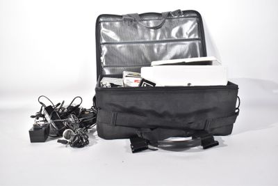 a black bag with a laptop in it sitting on the floor