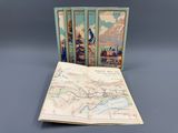 trois livres avec des cartes en couverture, posés sur une table